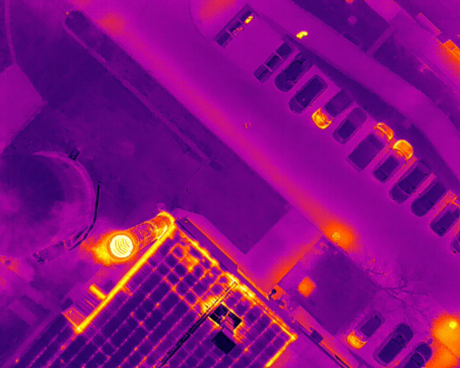 Thermal image of buildings rooftop streets cars in the city